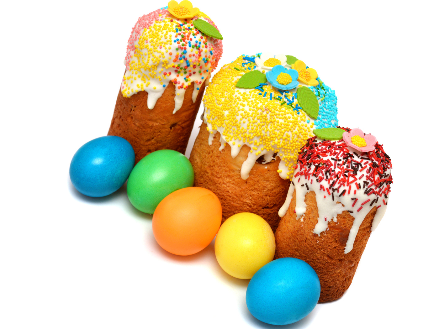 Three Easter cakes with painted eggs on a white background for the holiday Easter