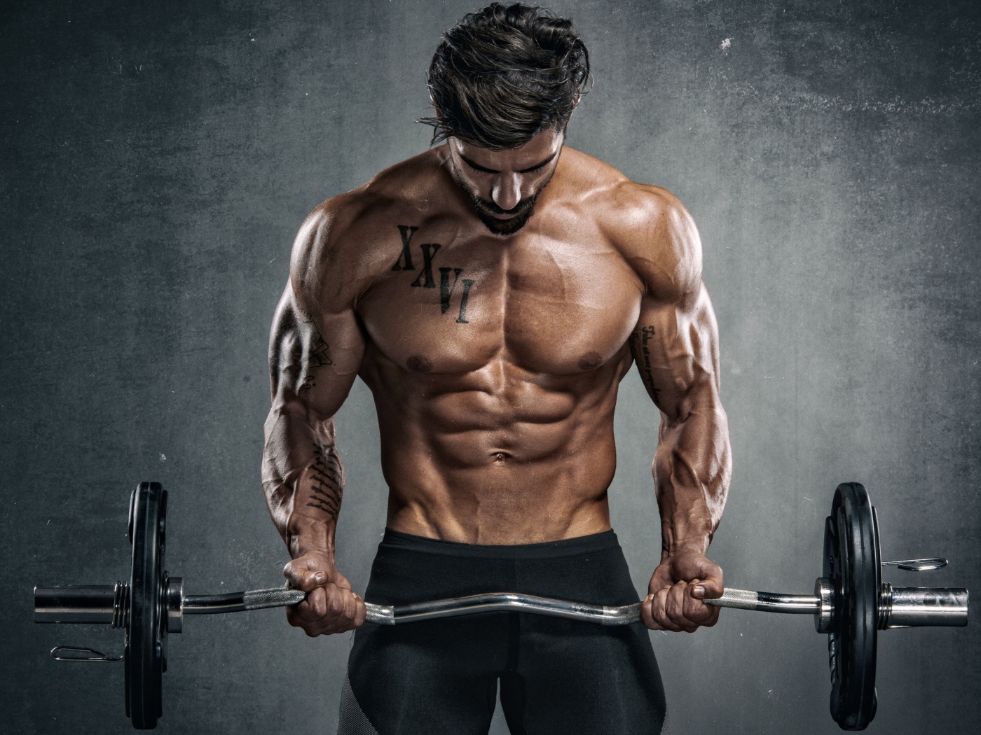 Inflated man with a dumbbell in his hands on a gray background