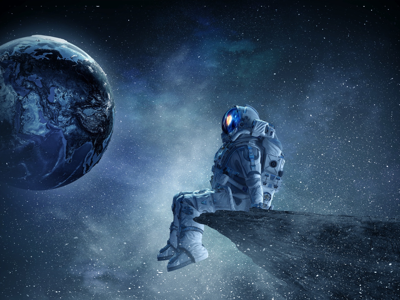 Мужчина астронавт смотрит на планету земля из космоса 