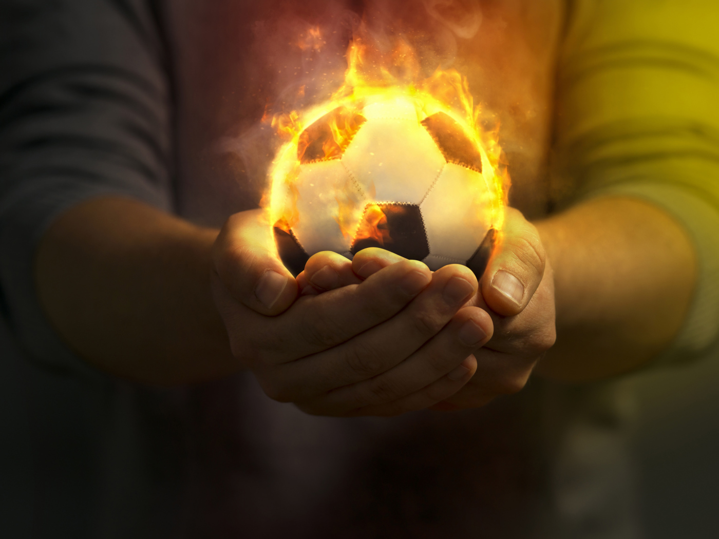 Fire soccer ball in the hands