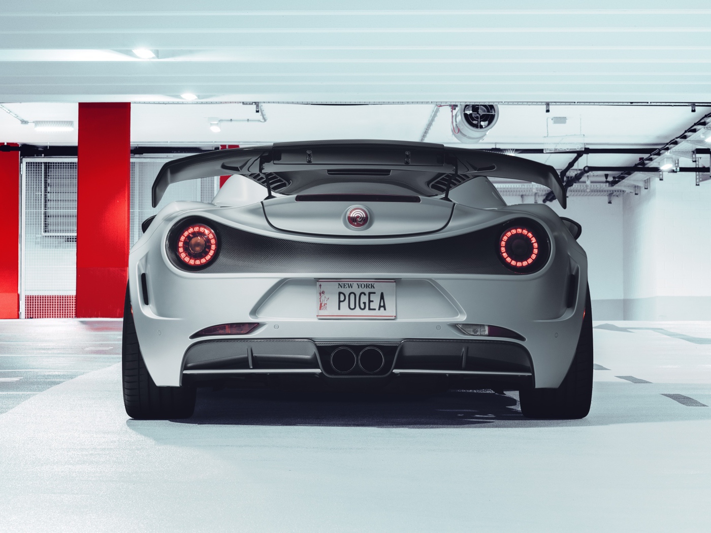 Серый автомобиль Pogea Racing Nemesis 2020 года вид сзади