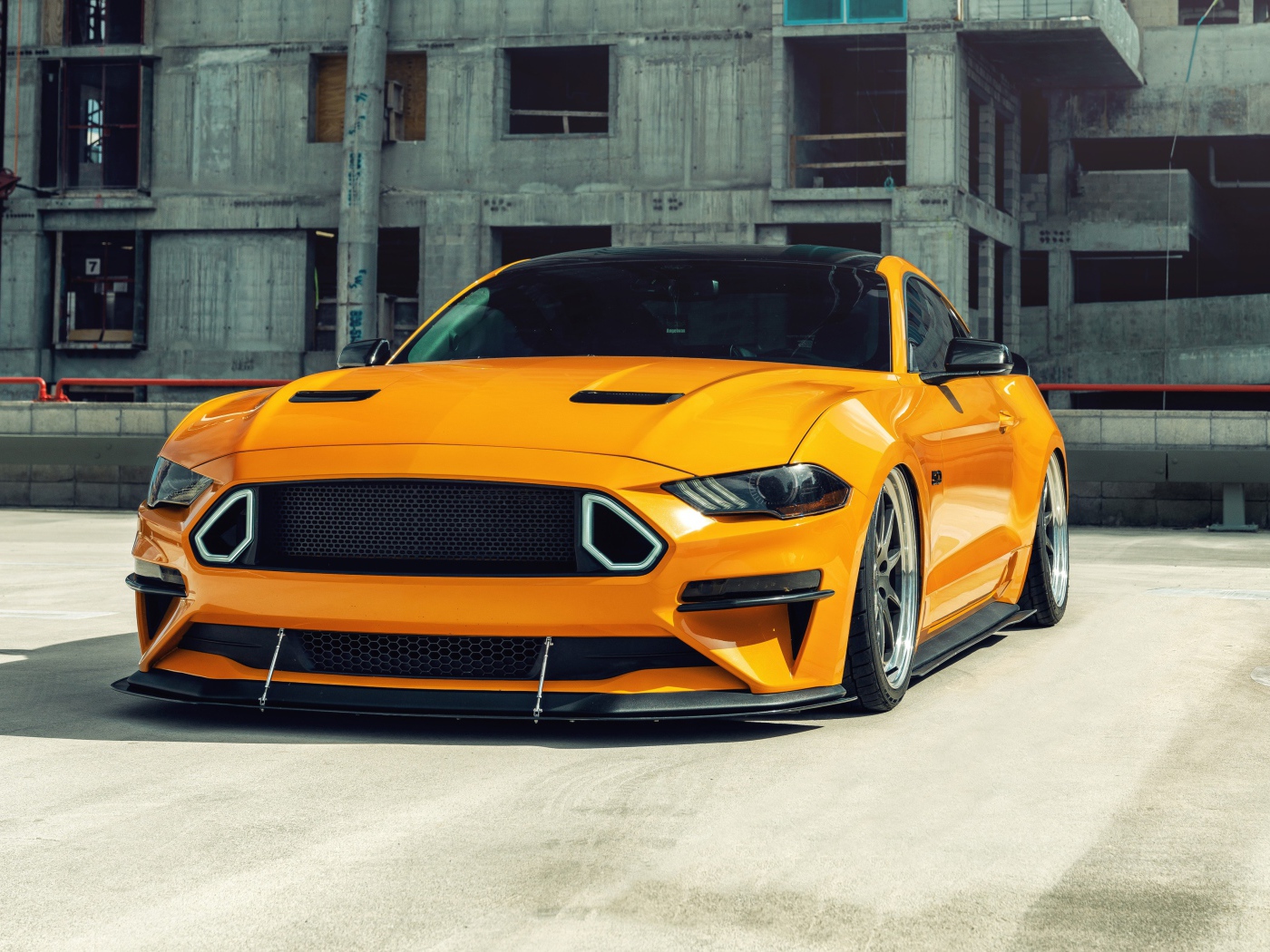 Оранжевый автомобиль  Mustang на стройке 