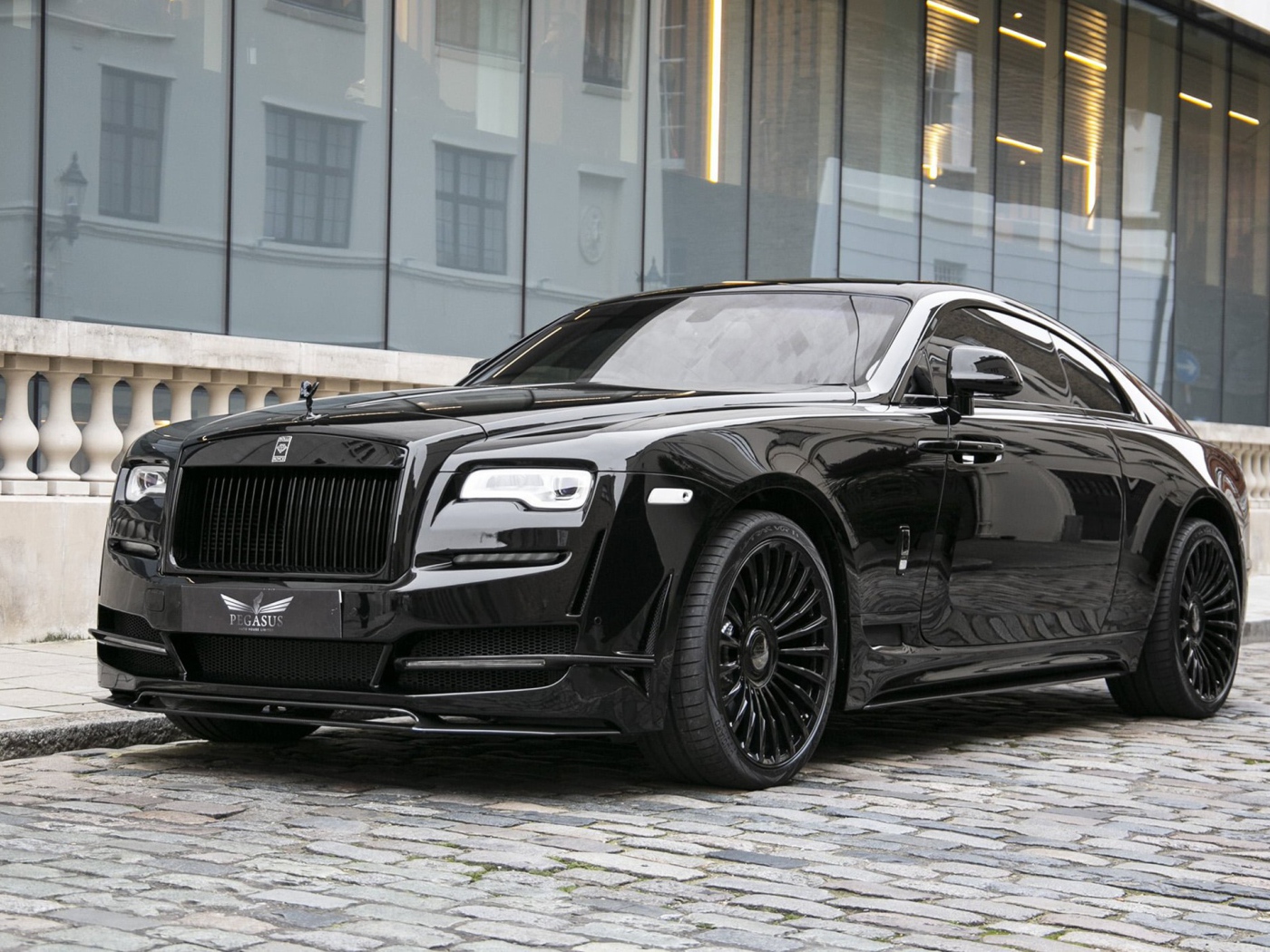 Черный автомобиль Rolls-Royce Wraith у здания 