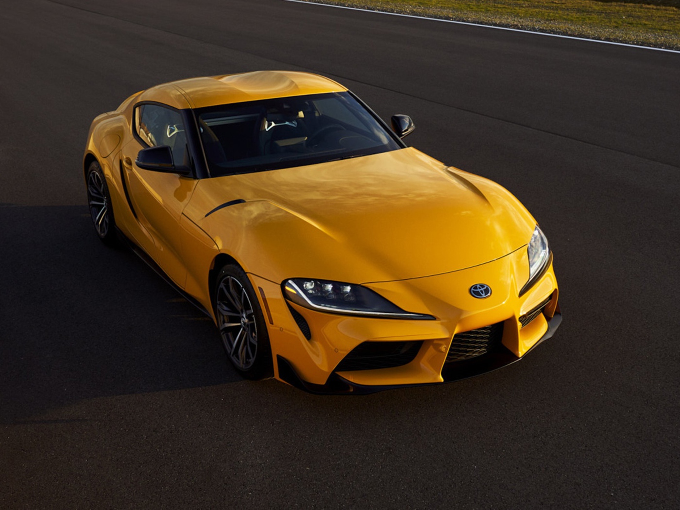 Желтый автомобиль  Toyota GR Supra, 2021 года на трассе 