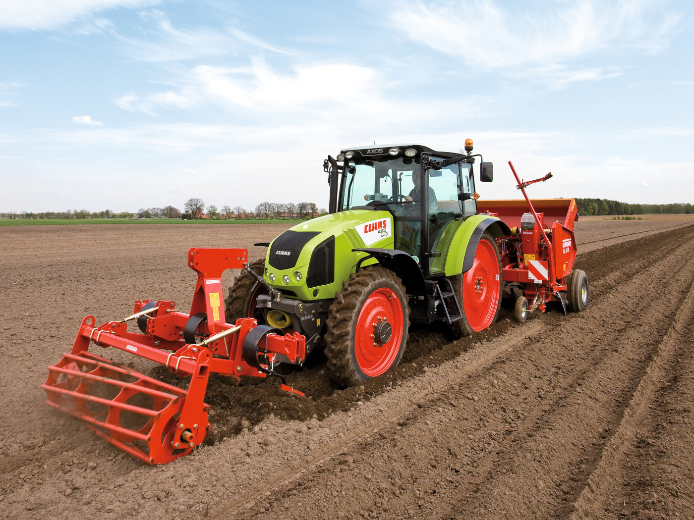 Большой комбайн сеет в поле 