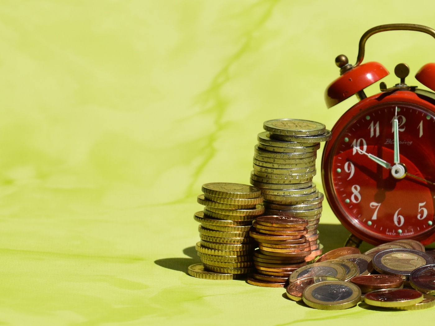 Красный будильник с монетами один евро 