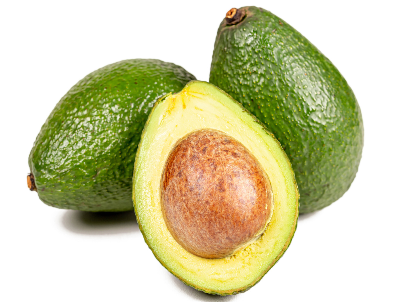 Green avocado fruit on white background