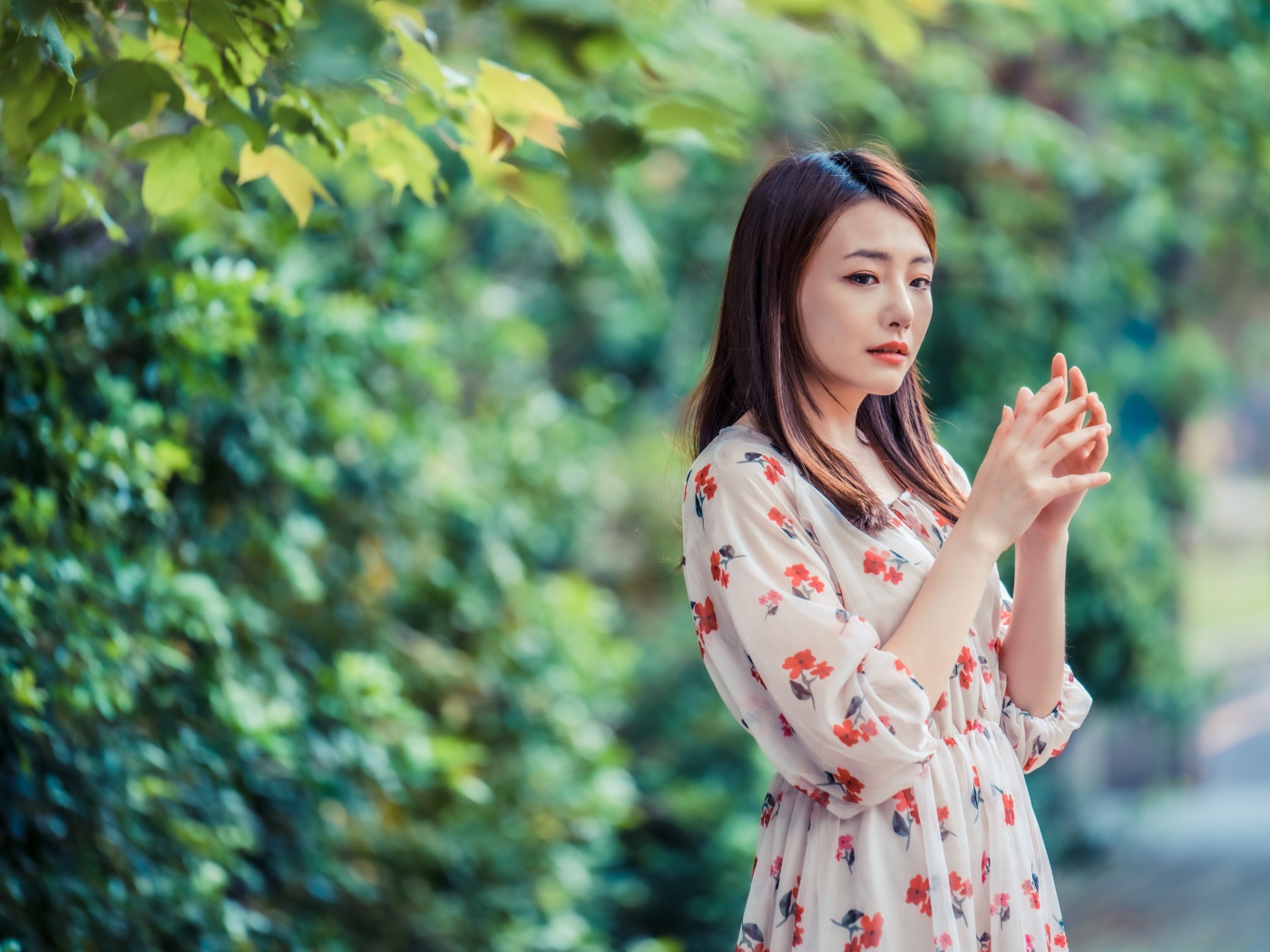 Красивая девушка азиатка в платье в парке