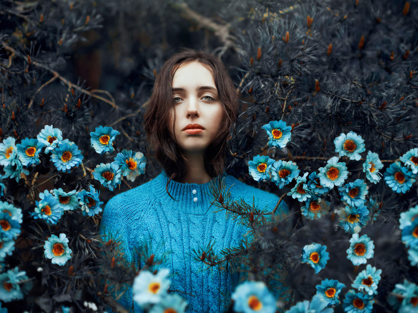 Beautiful girl spiny thickets with blue flowers