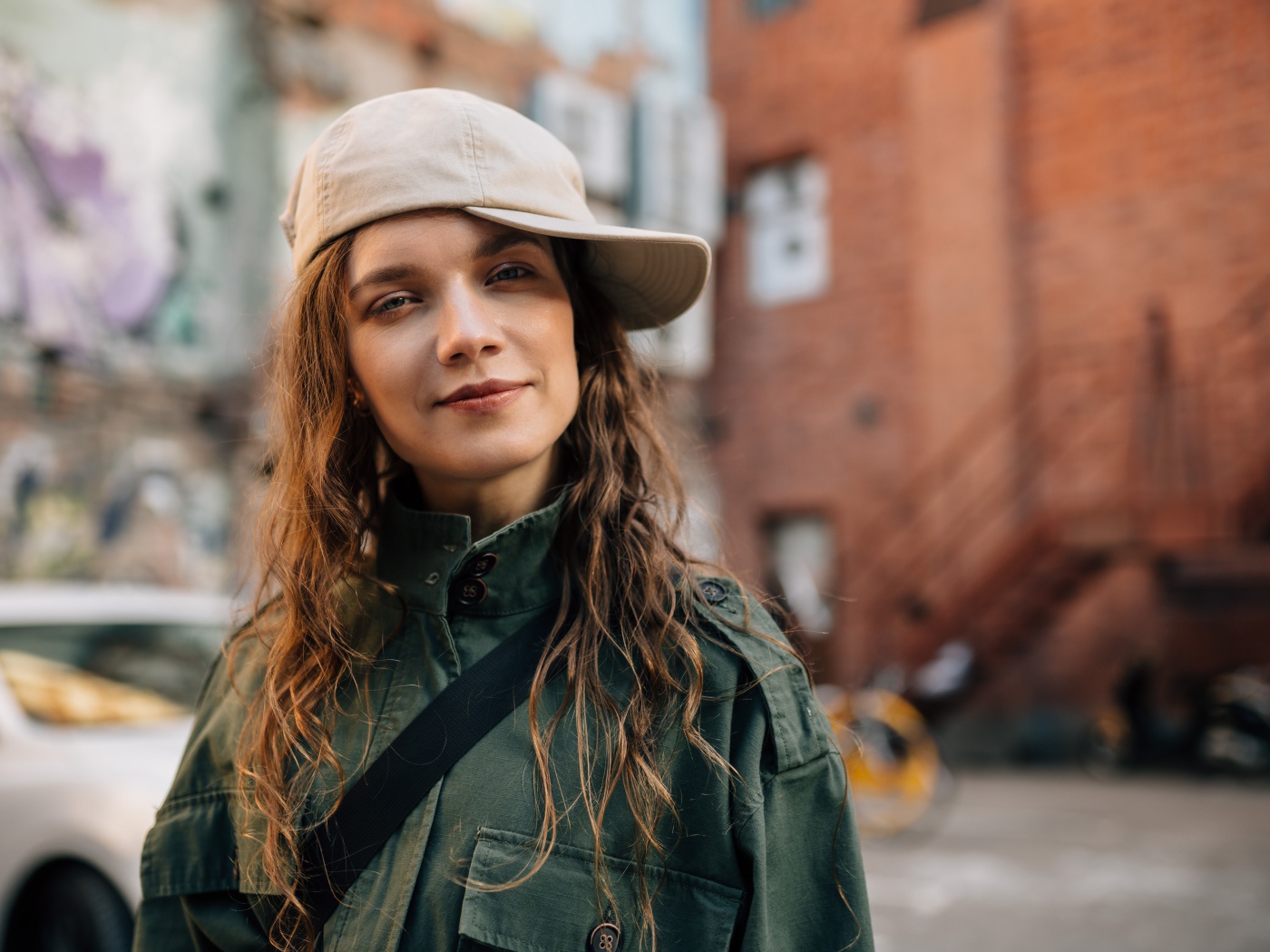 Young fashionable girl in a cap in the city