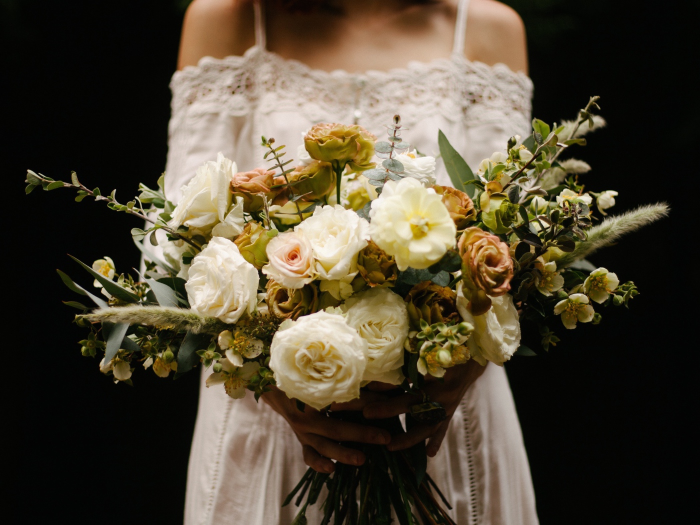 Beautiful bridal bouquet with white roses in hands