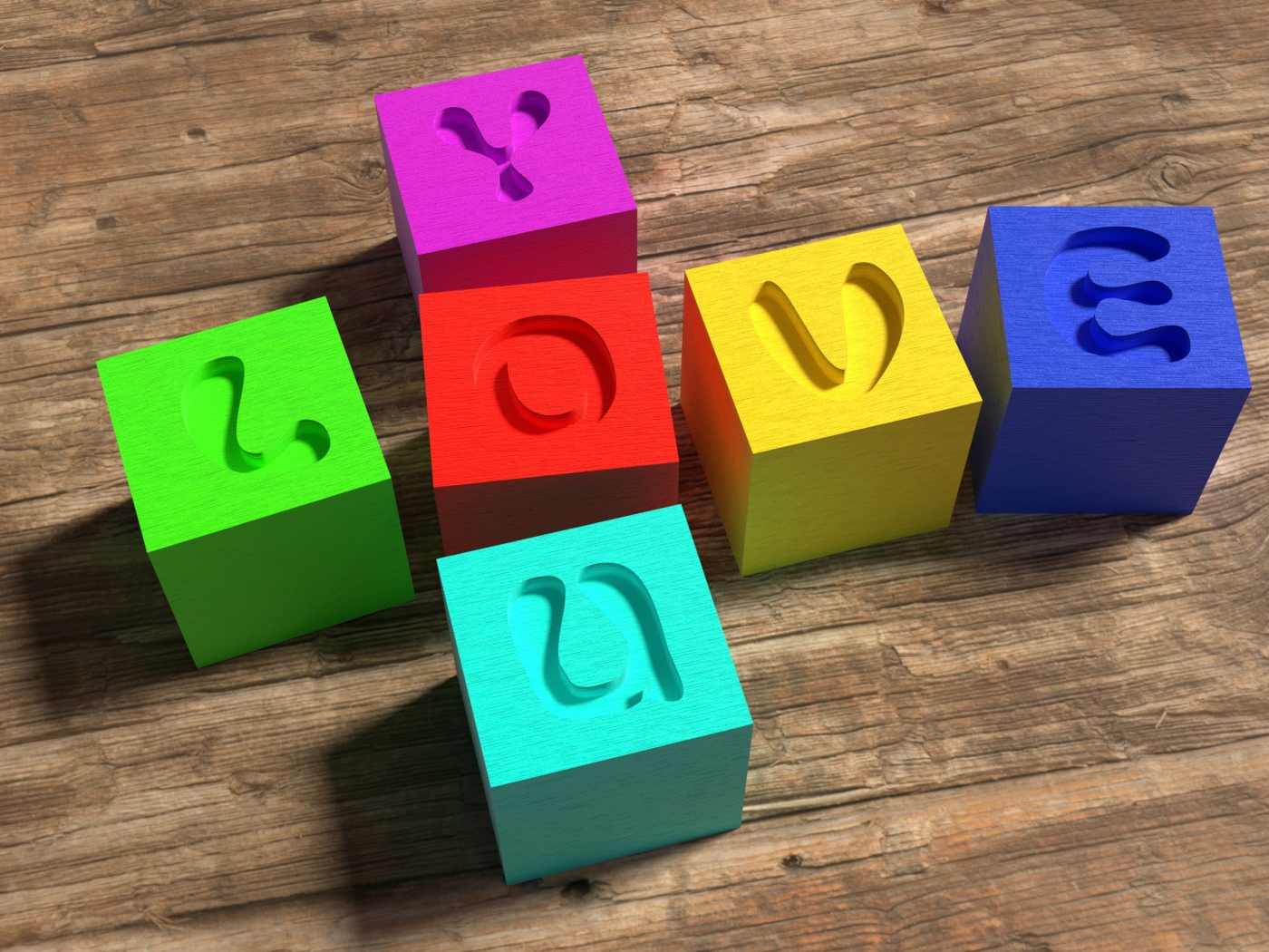 Разноцветные кубики с надписью Love  на деревянном столе 
