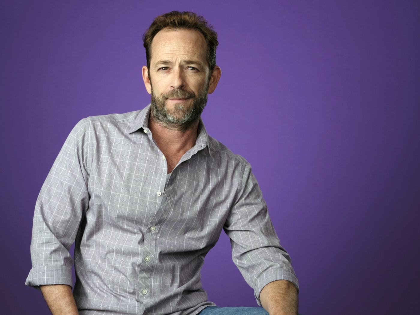 Американский актер Люк Перри в рубашке на сиреневом фоне