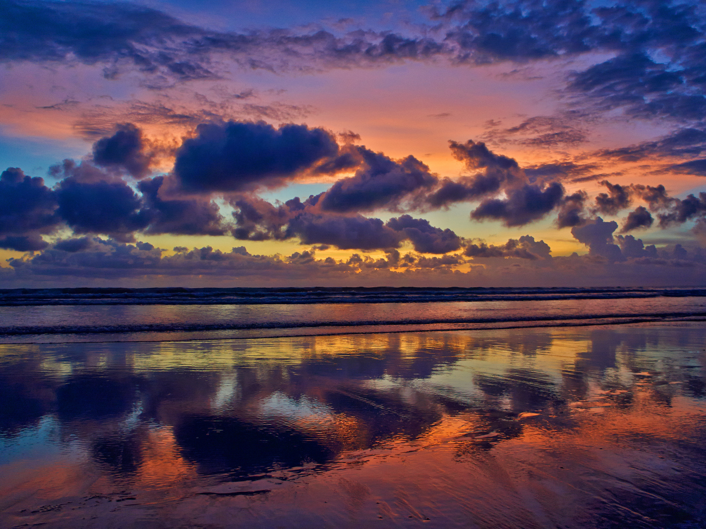 Черные тучи отражаются в морской воде на закате