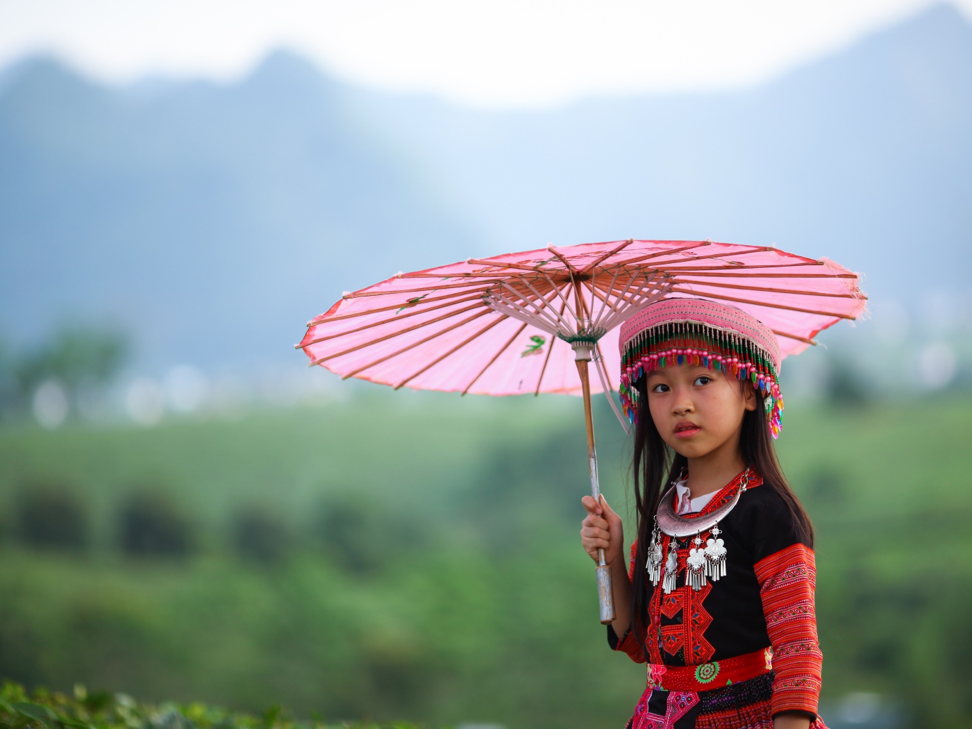 Маленькая девочка азиатка с розовым зонтом