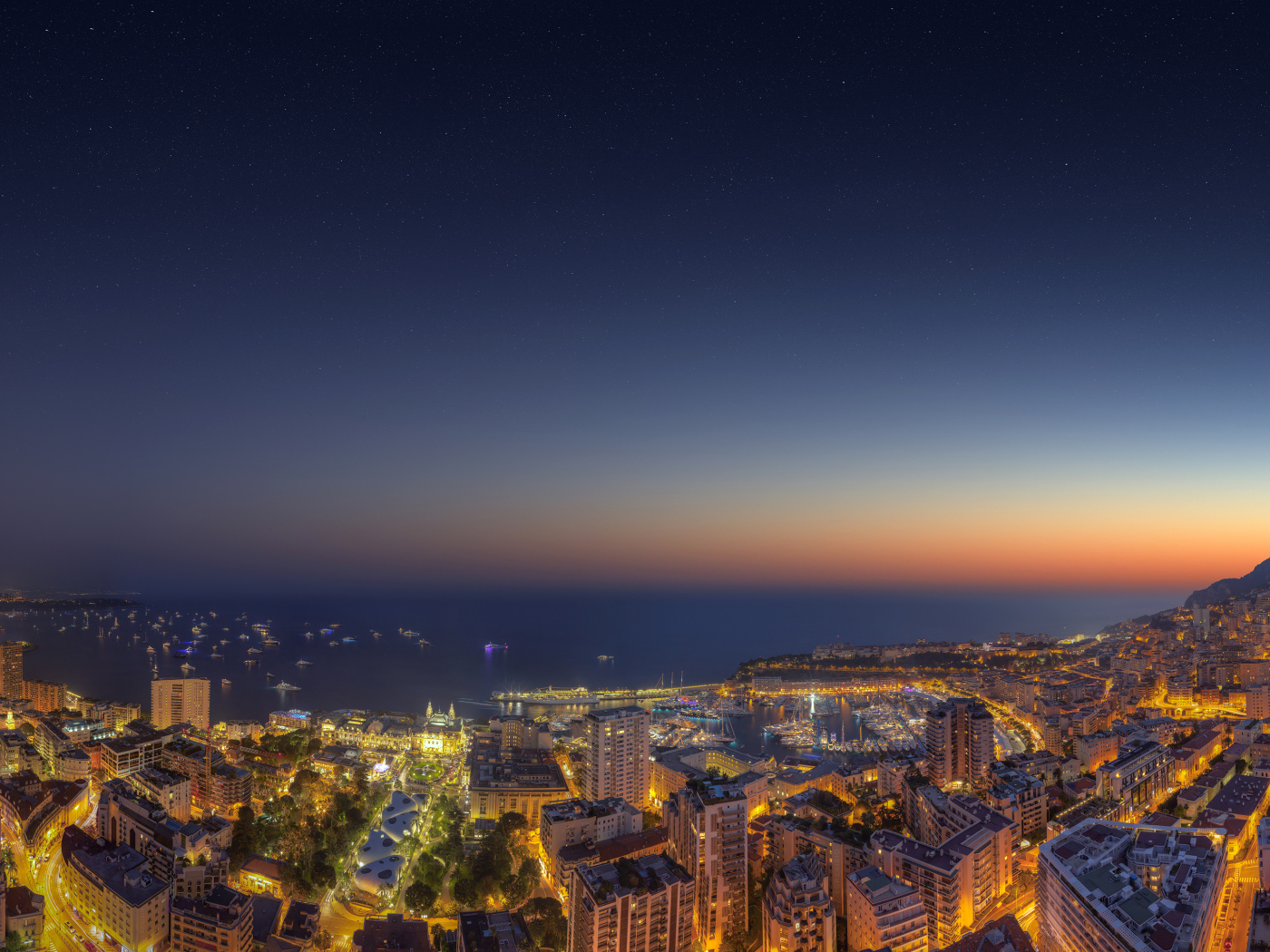 View of the night city of Monaco under a blue sky