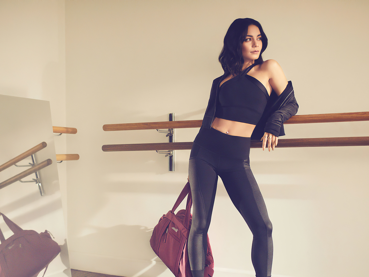 Актриса Ванесса Хадженс в черном костюме на тренировке