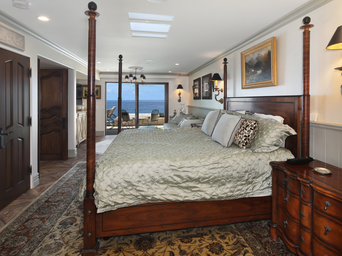 Большая деревянная кровать в спальне с видом на море 