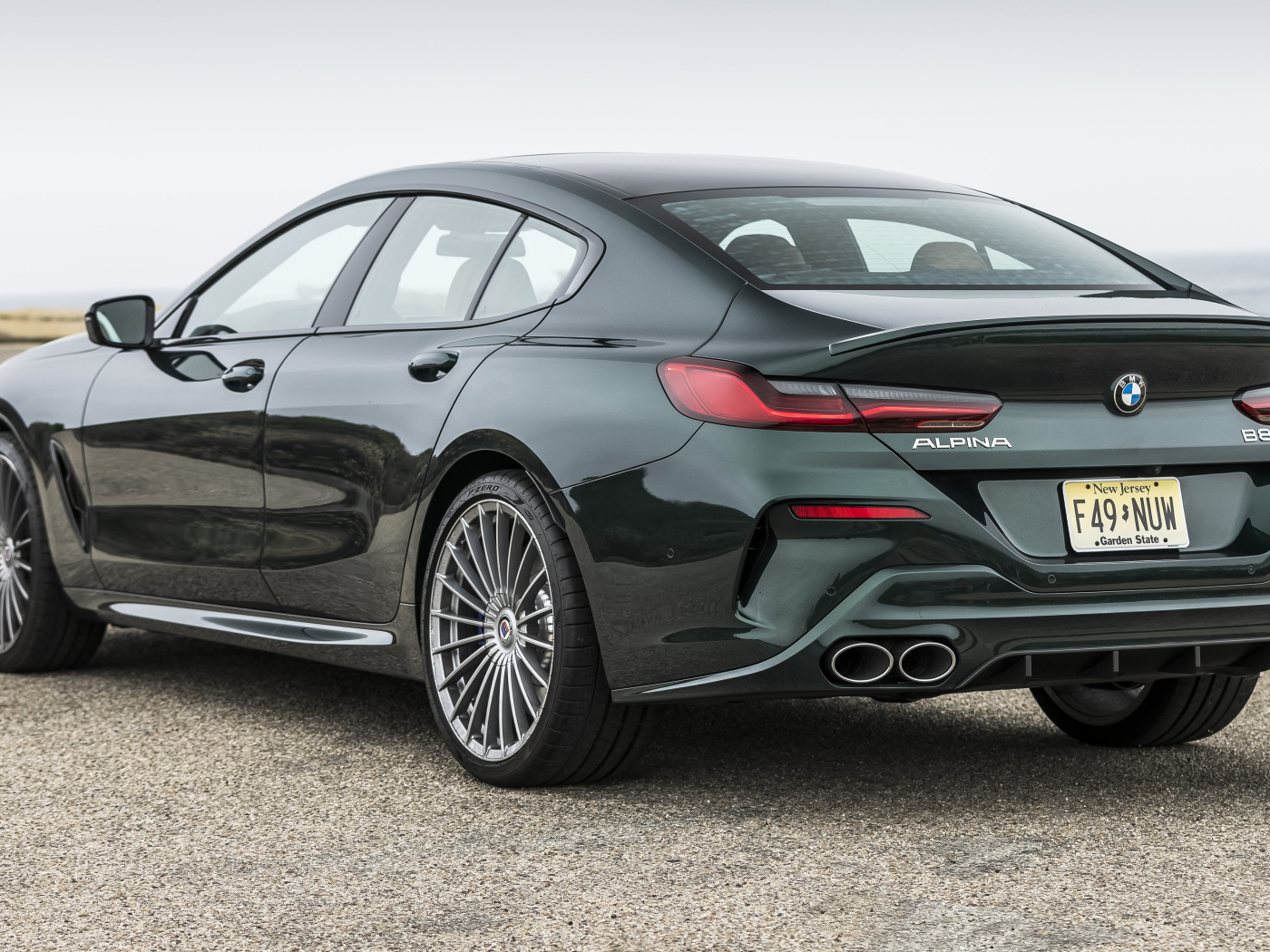 Черный автомобиль Alpina B8 Gran Coupé, 2022 года вид сзади