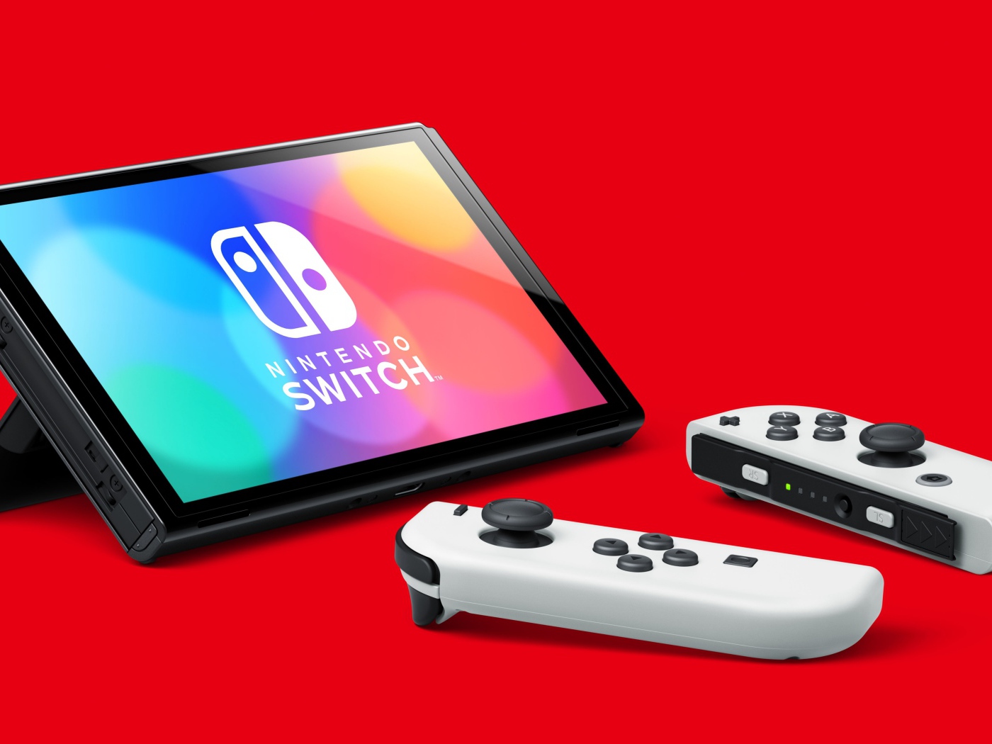 Nintendo Switch OLED game console on red background