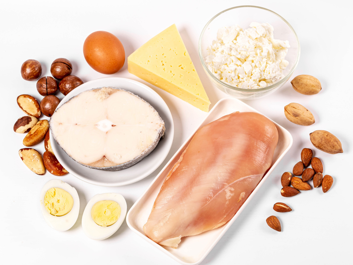 Fresh chicken, fish, nuts, cottage cheese and eggs on the table