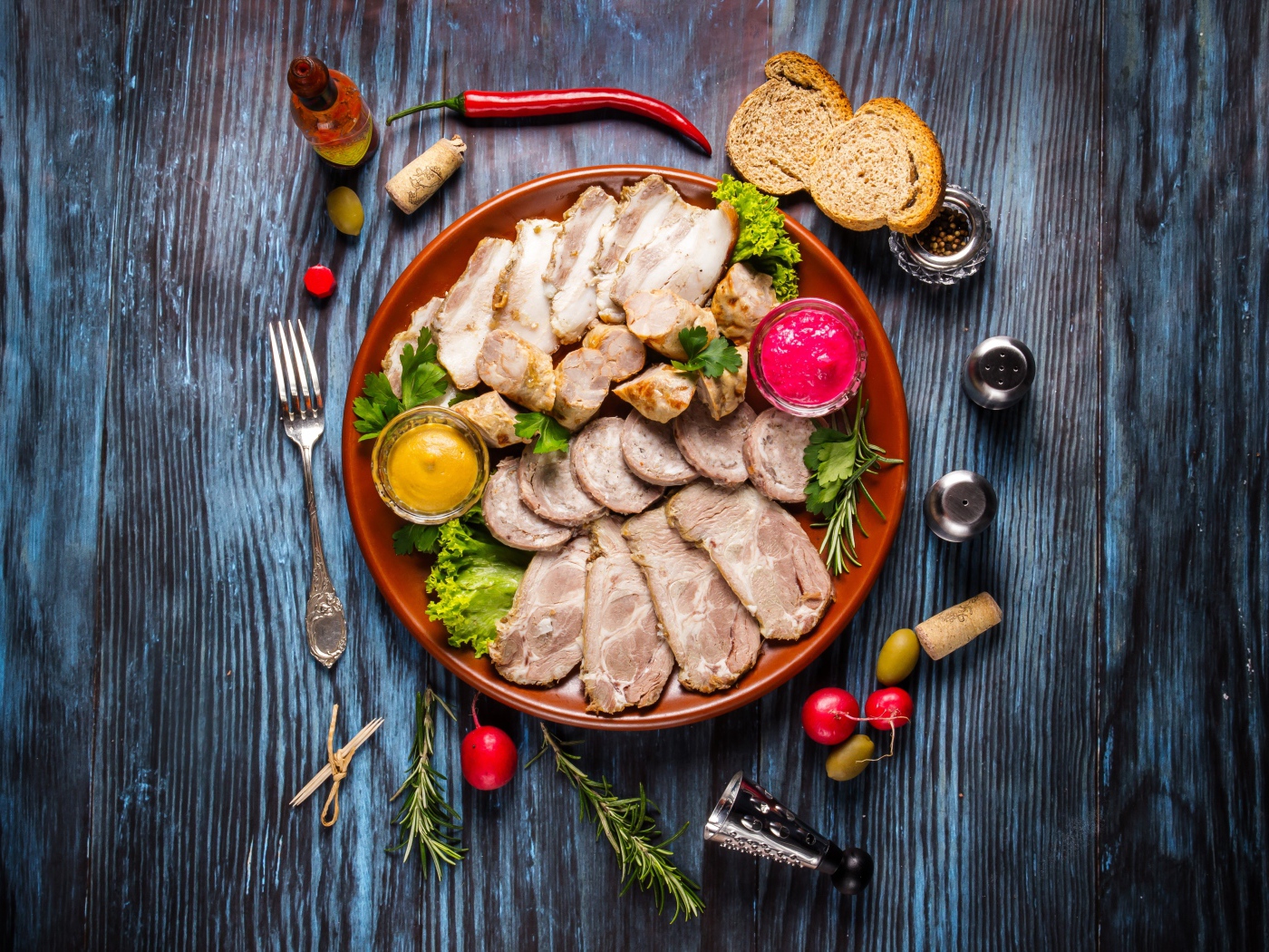 Meat platter in a plate with sauce and herbs