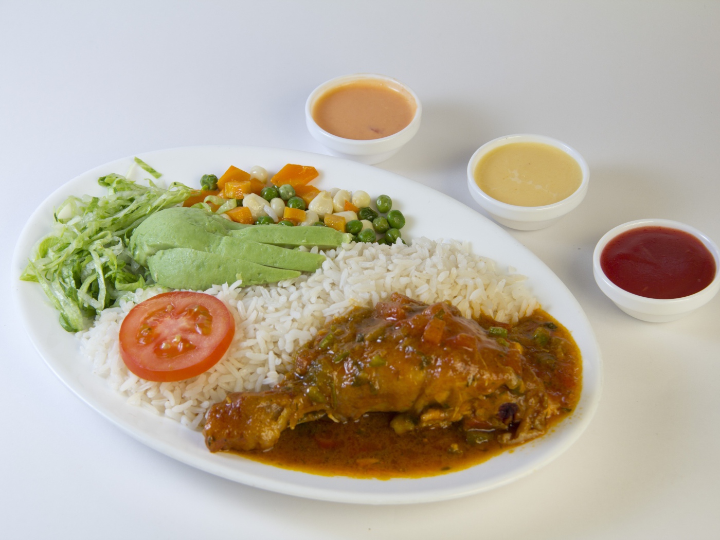 Rice with chicken and vegetables on the table with sauce