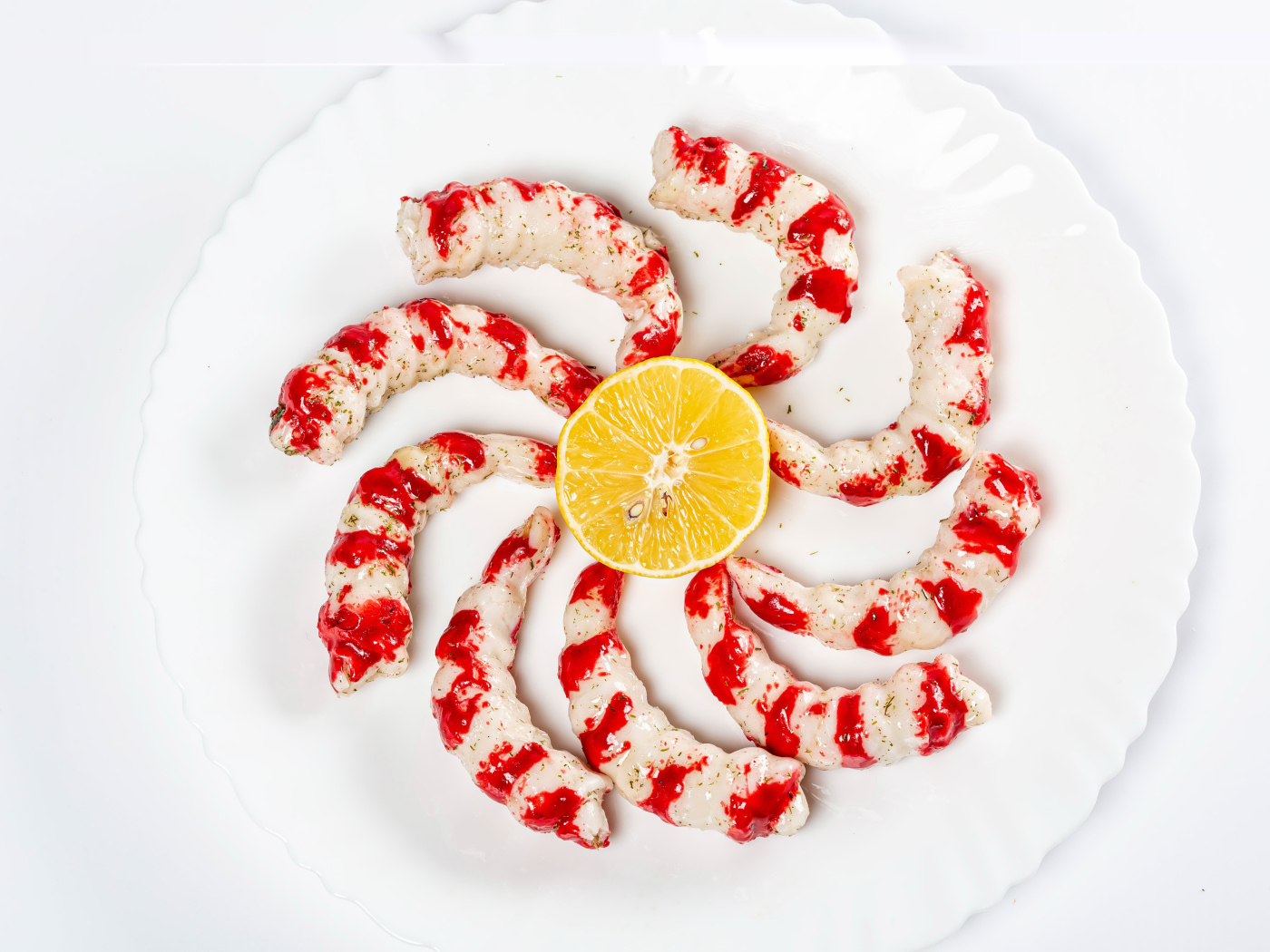 Tiger prawns on a plate with lemon on a white background