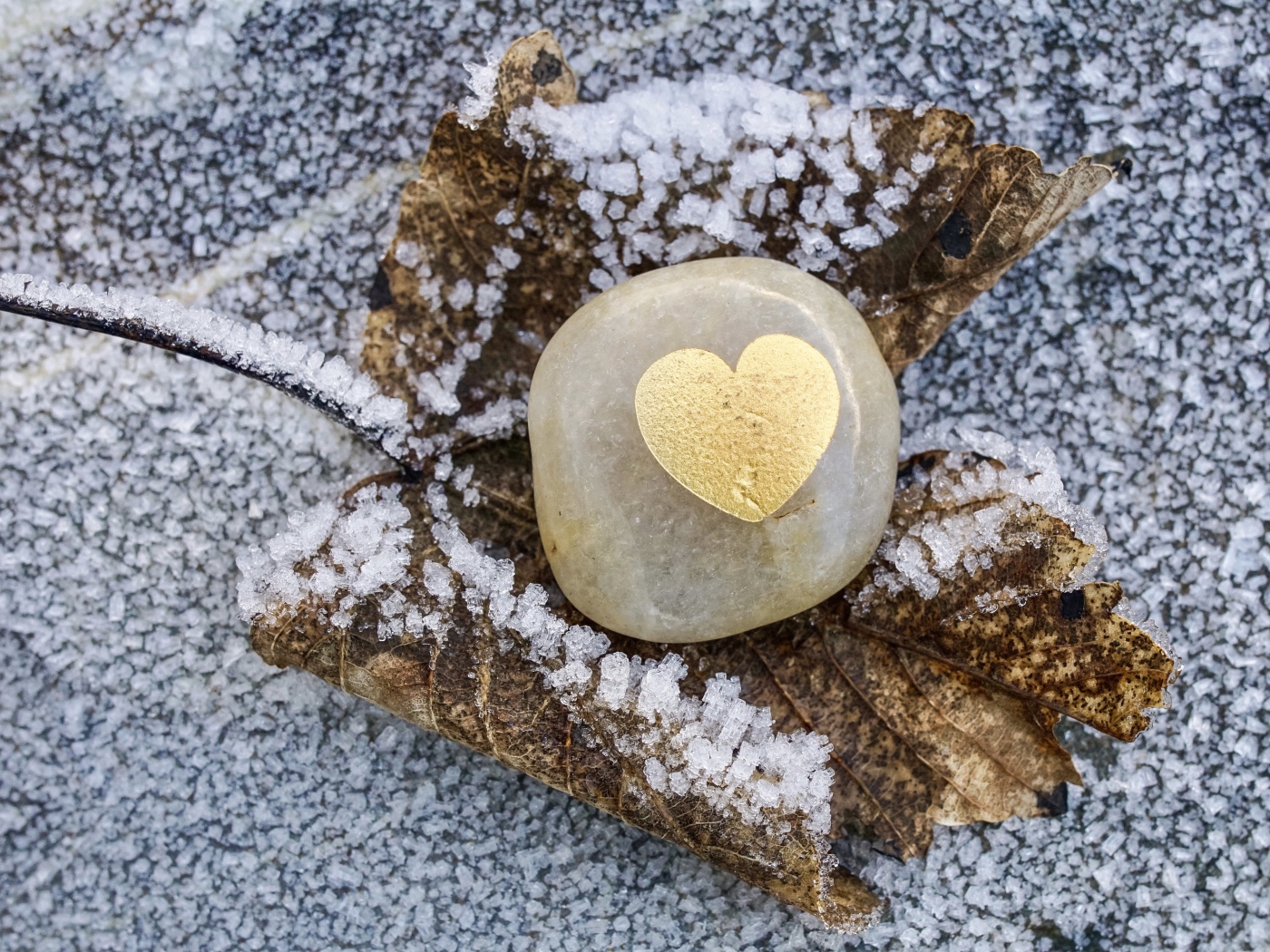 Heart in stone on snowy ground