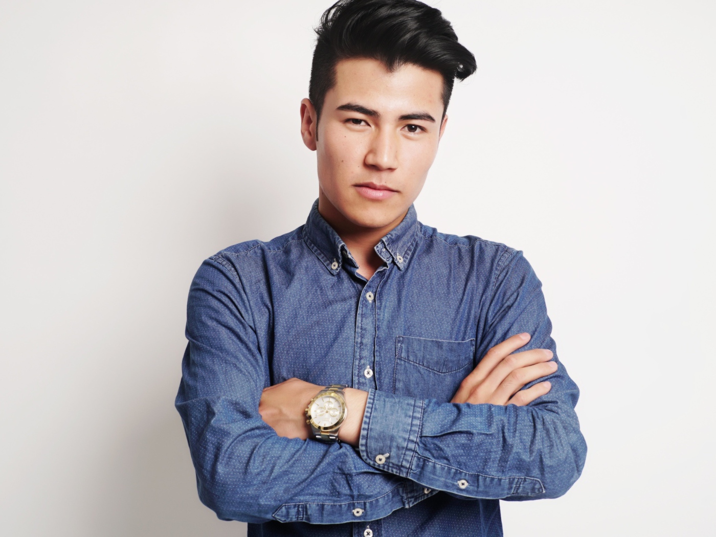 Мужчина в синей рубашке на сером фоне 