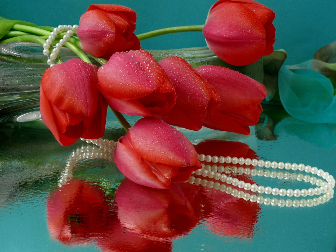Bouquet of red tulips and pearl beads