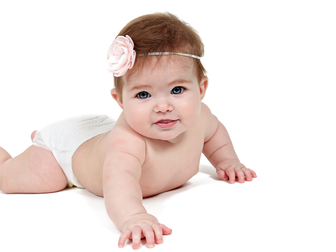 Smiling little blue-eyed baby on a white background