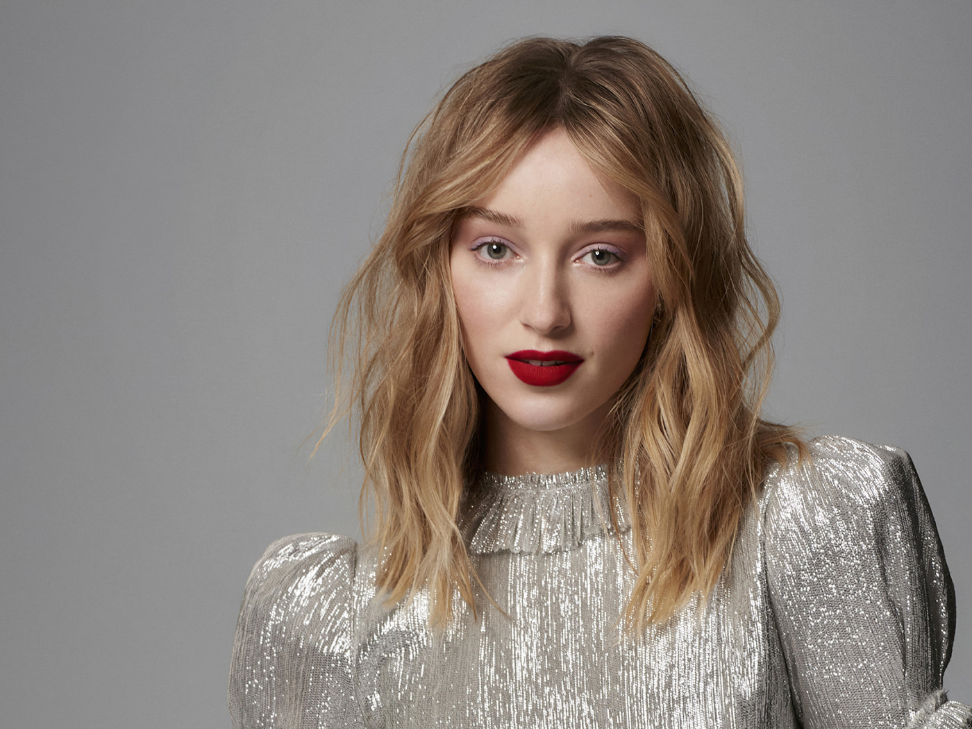 Красивая девушка актриса Фиби Дайневор на сером фоне в блестящем платье