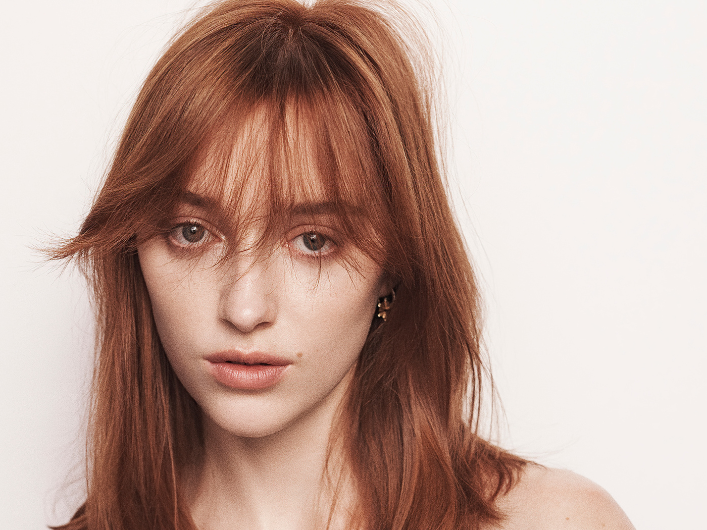 Рыжеволосая актриса Фиби Дайневор на белом фоне