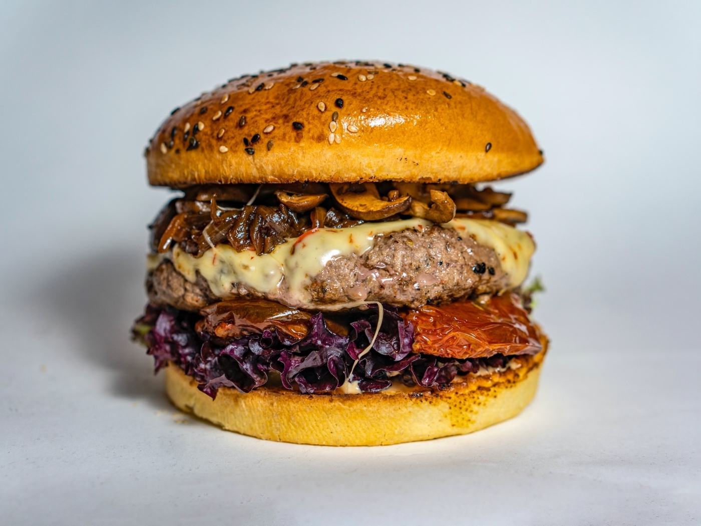 Ароматный сочный гамбургер на сером фоне крупным планом