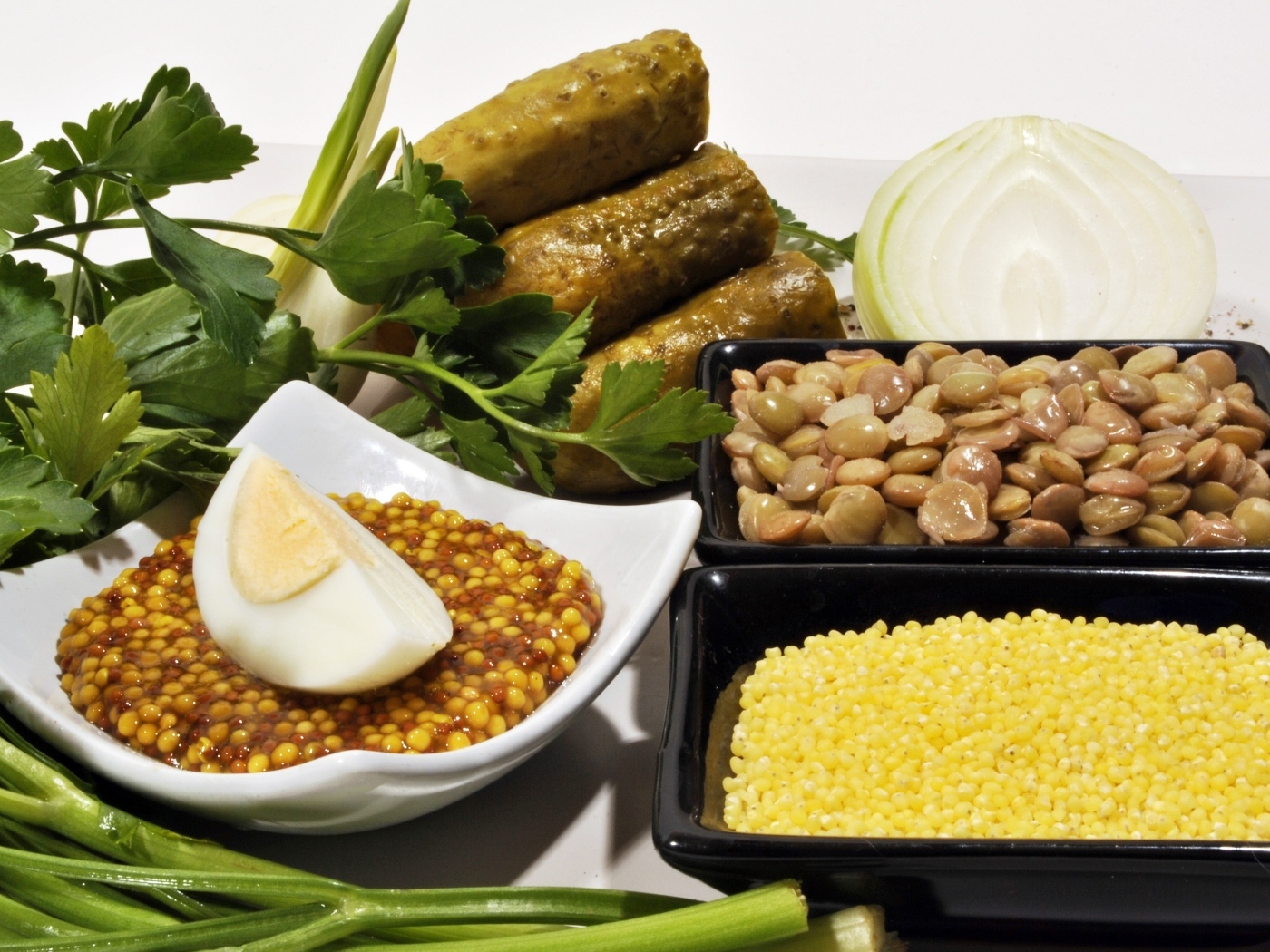 Пшено на столе с огурцами луком и горчицей