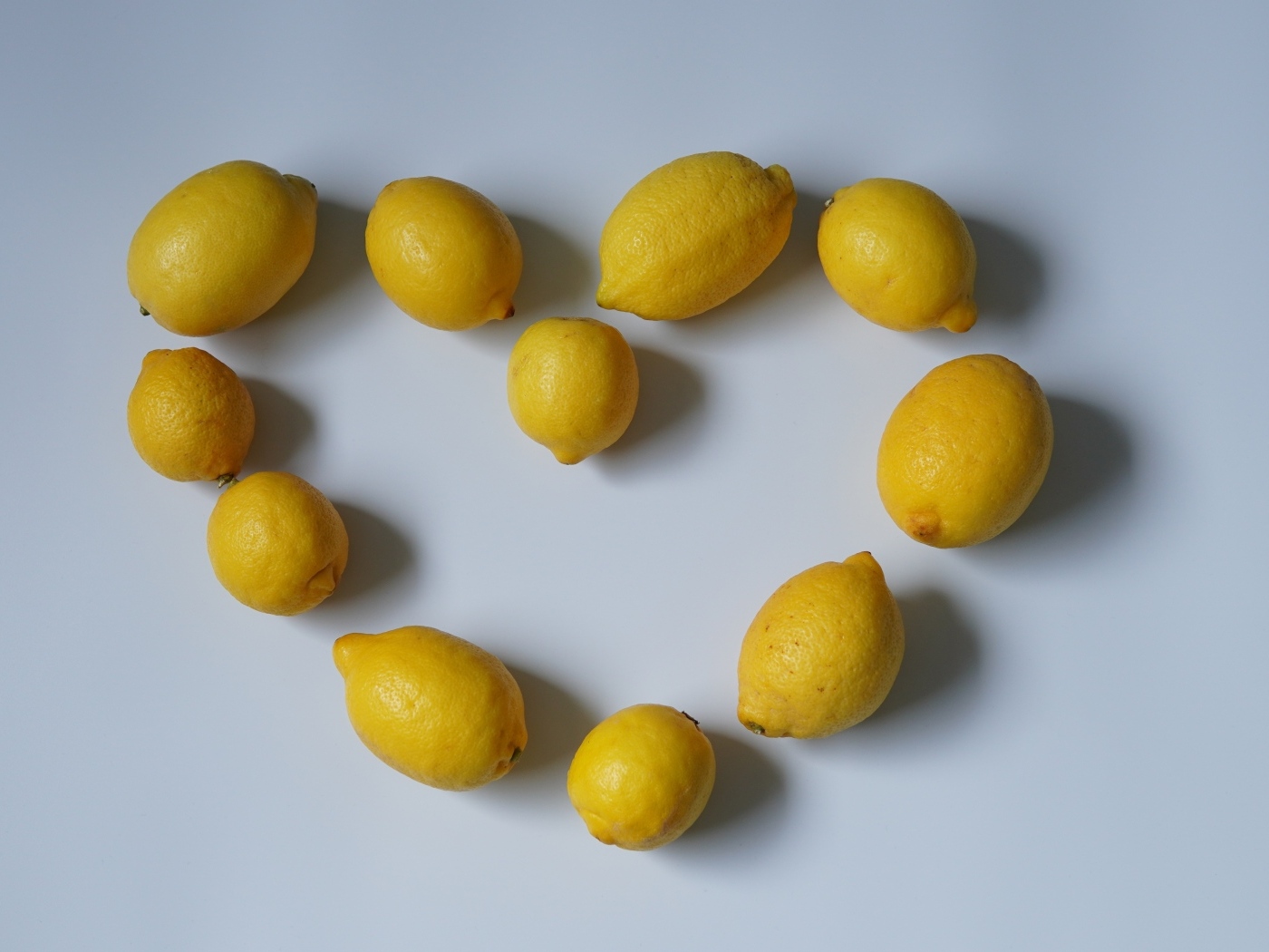 Сердце  из лимонов на сером фоне