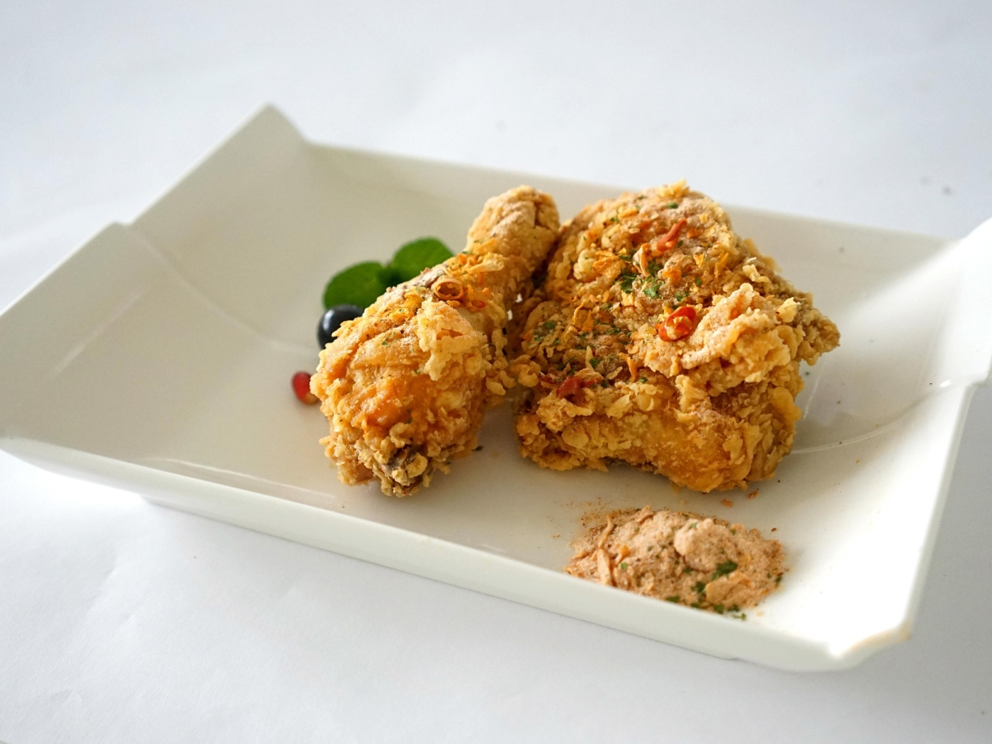 Жареная хрустящая курица в тарелке на столе