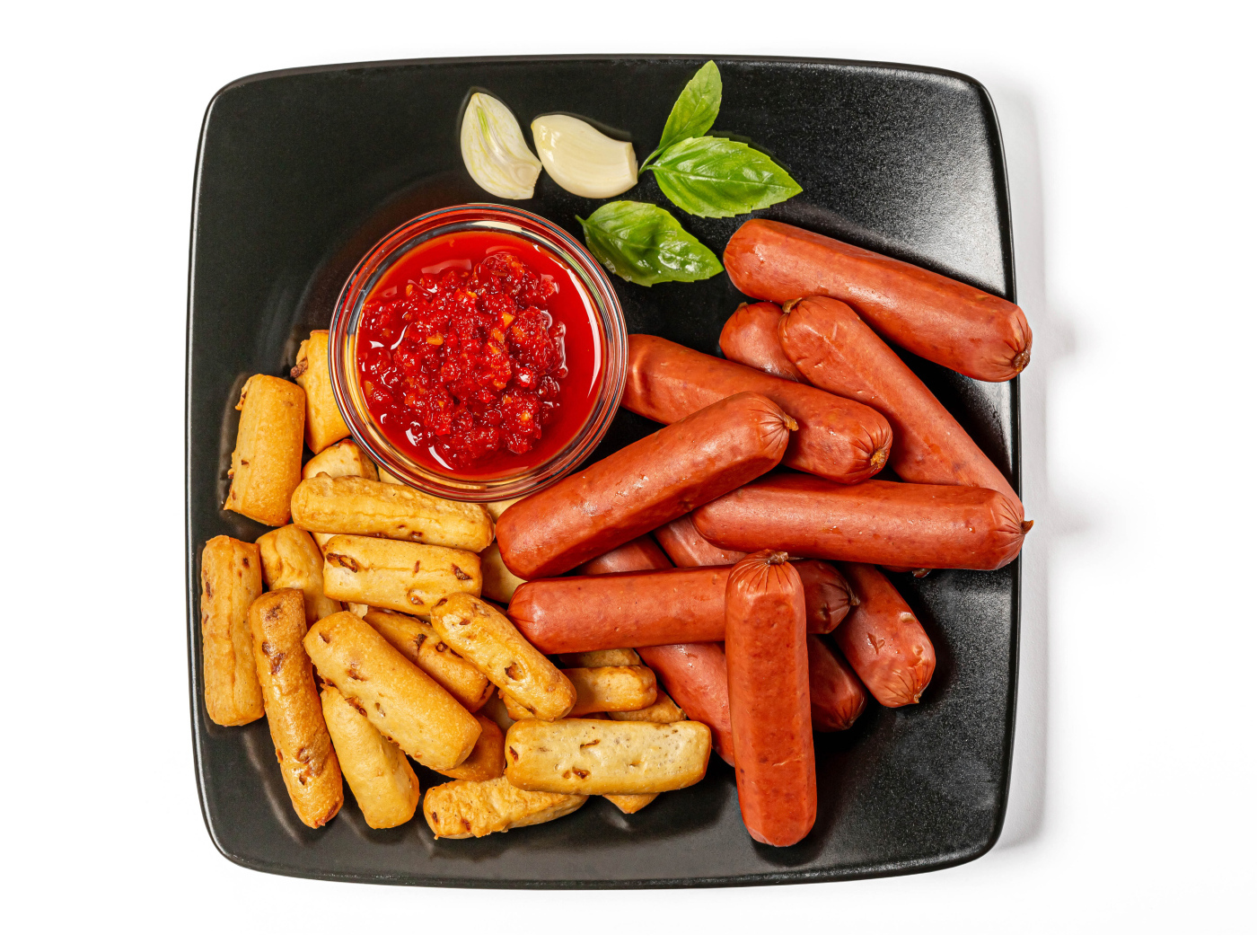 Hot sausages with pastries on a plate