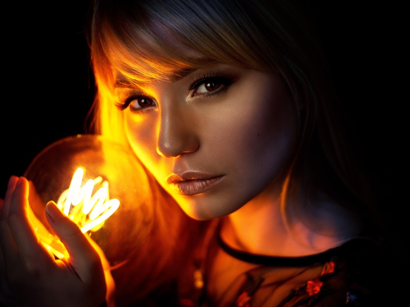 Кареглазая девушка с лампочкой в руках