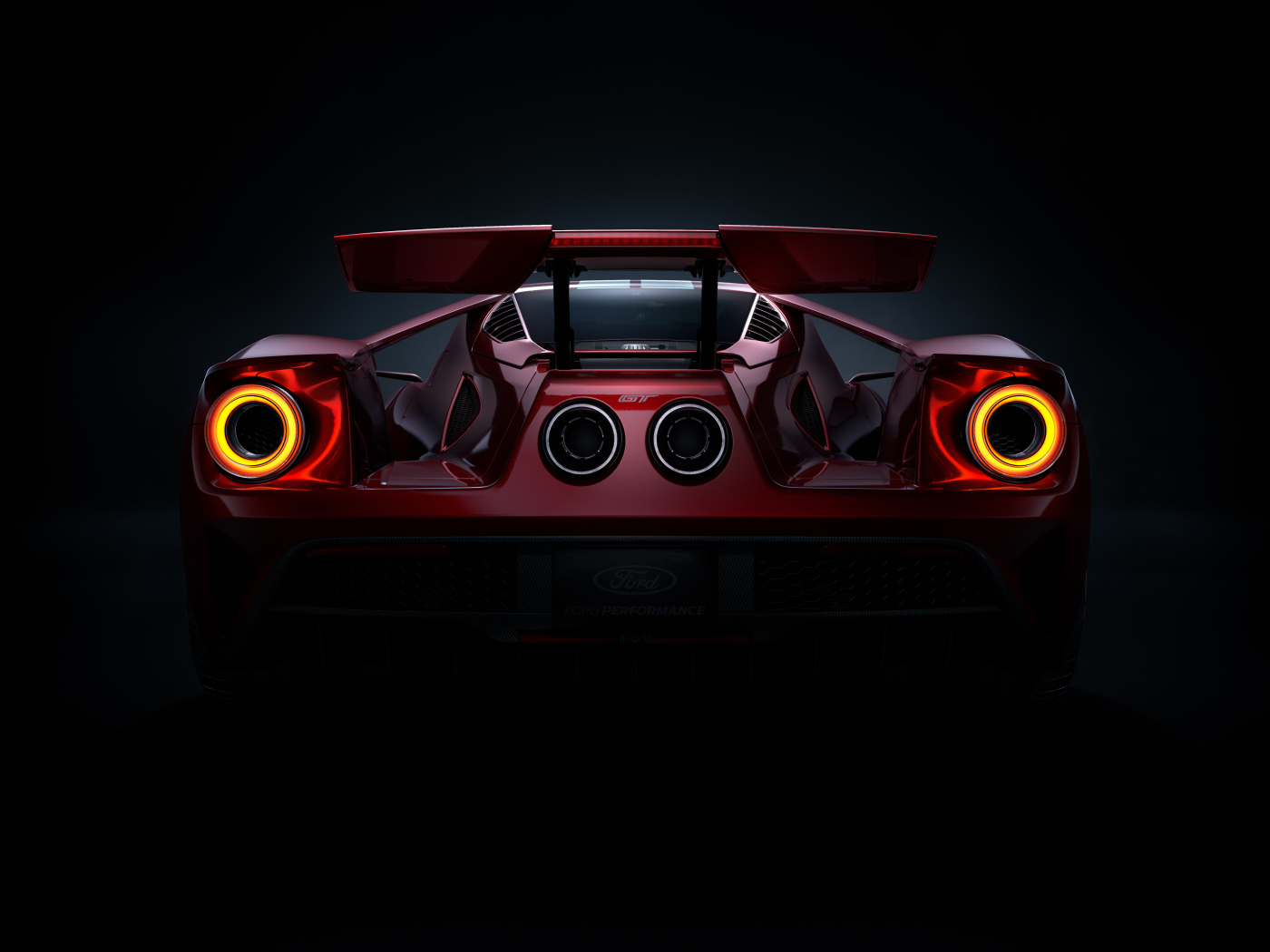 Вид сзади на автомобиль Ford GT  на черном фоне