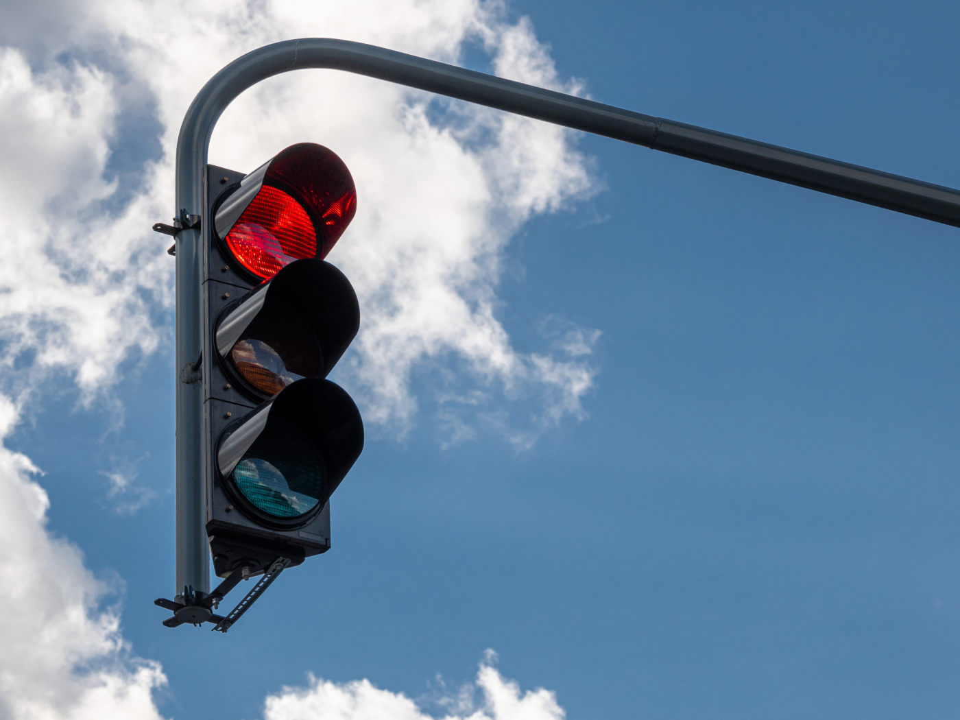 Красный свет светофора на фоне неба