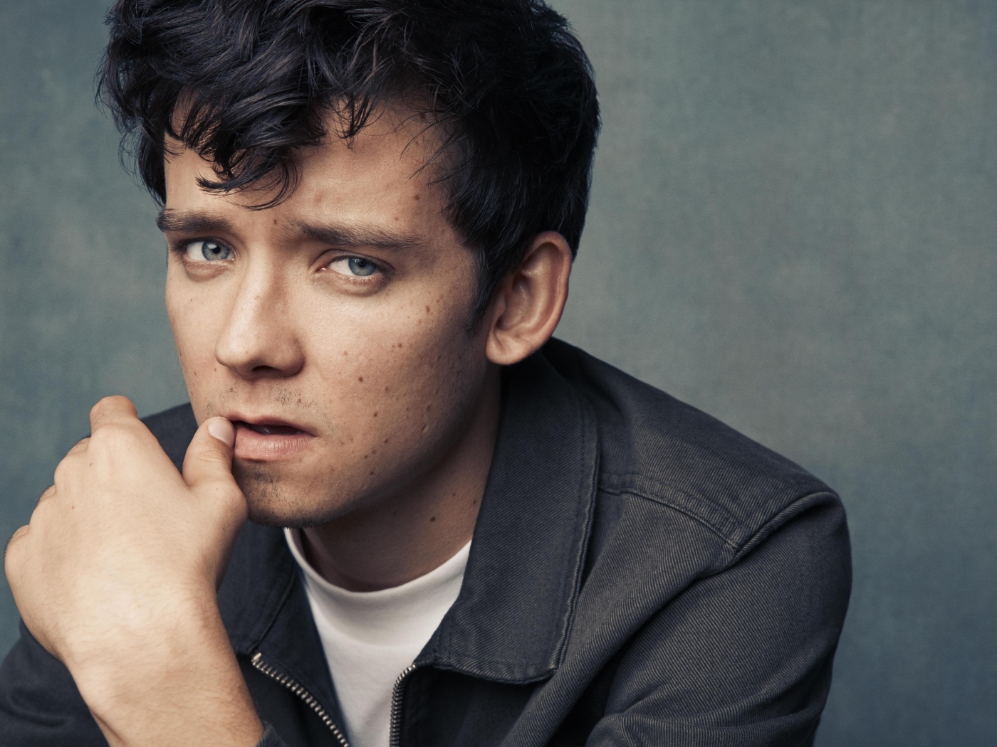 Актер Эйса Баттерфилд на сером фоне