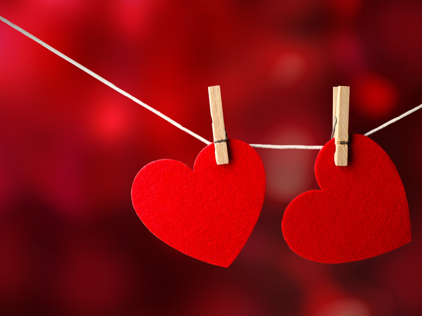 Два красных сердца висят на веревке
