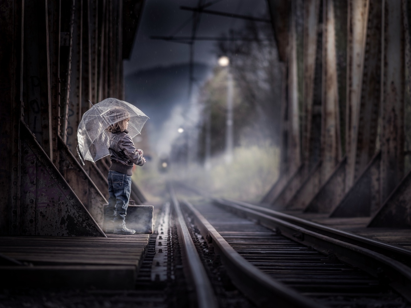Ребенок под зонтом у железной дороги