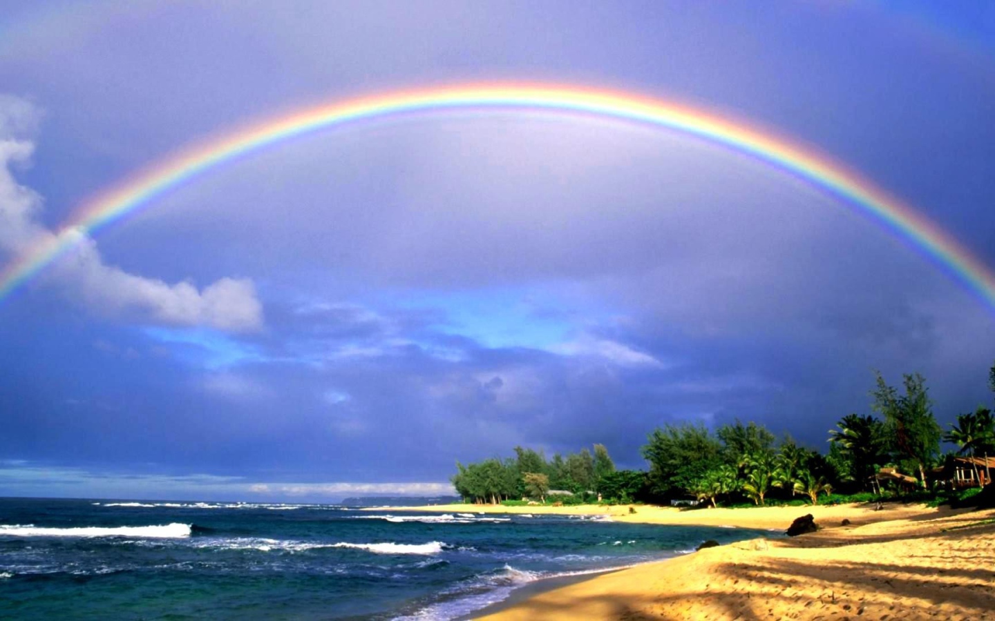 Rainbow over the sea and the beach