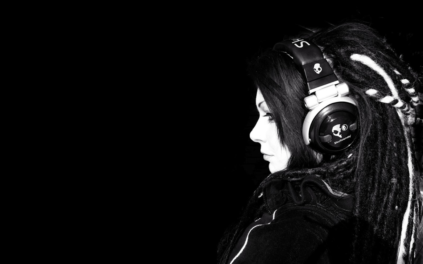 Girl in headphones on a black background