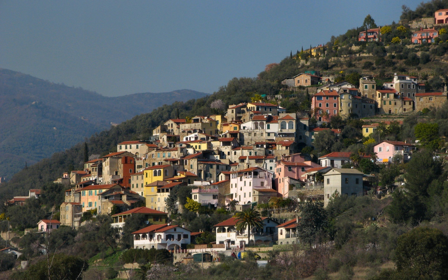 Дома на склоне горы на курорте Империя, Италия