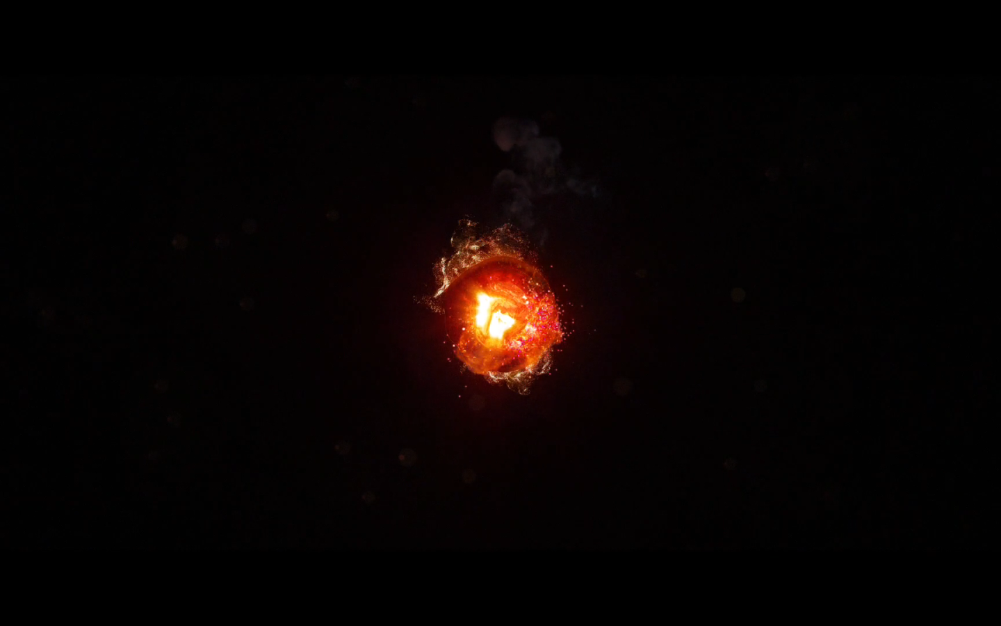 Горящий уголек, черный фон