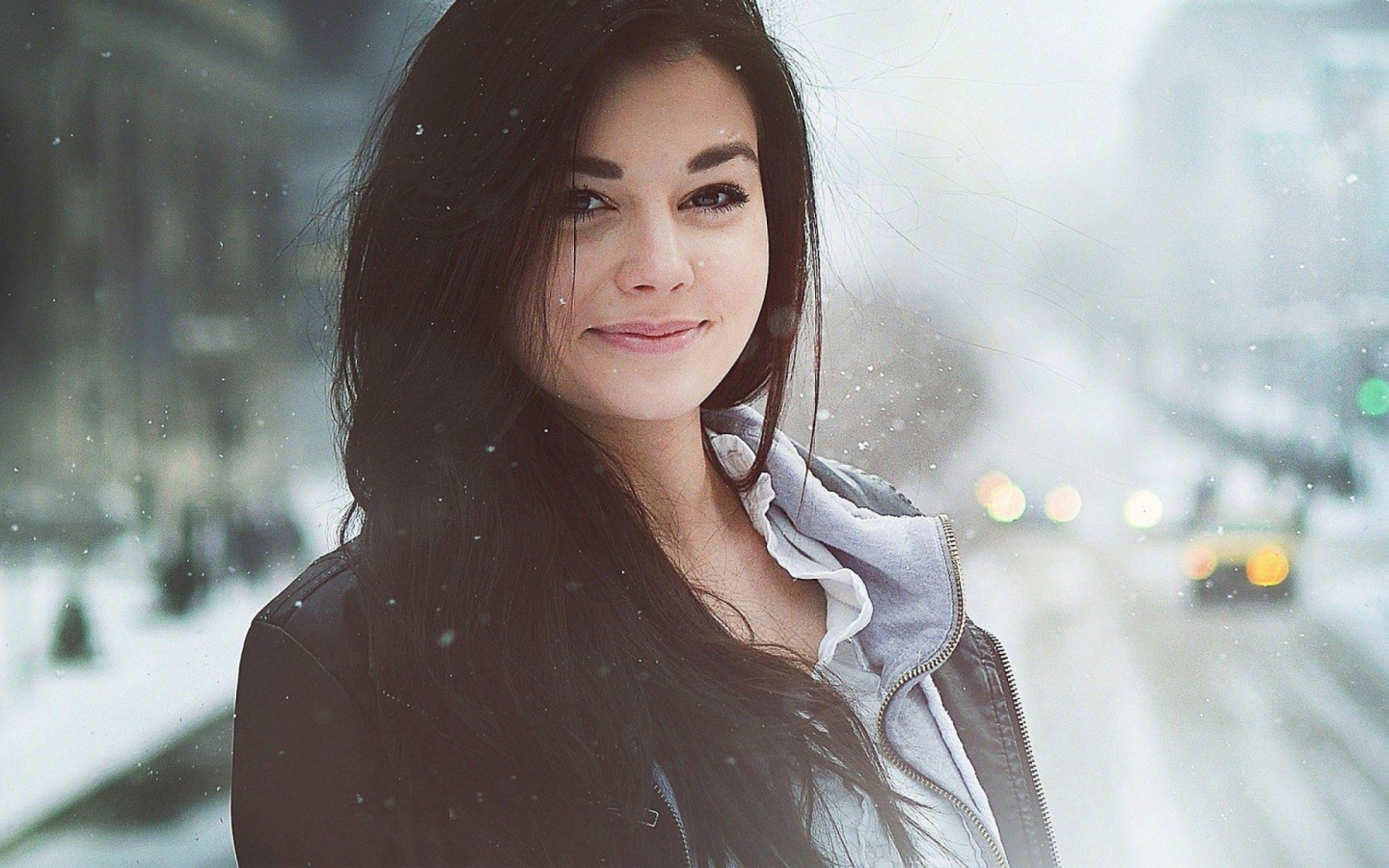 Brunette girl among snowfall